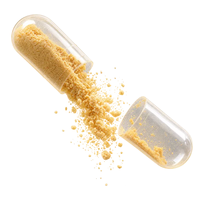 An opened capsule releasing powder